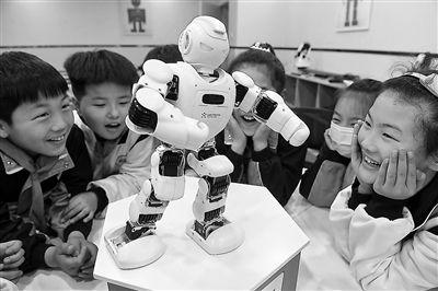 安徽省阜阳市颍东区和谐路小学学生在科技兴趣课堂上观看机器人表演技能。王彪 摄
