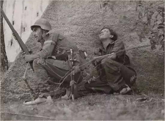 1936年摄于西班牙,跟在士兵身后的葛尔达·塔罗。