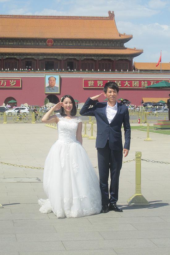 3、一对准备结婚的青年人在天安门前拍摄婚纱照。
