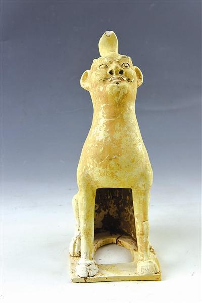 镇墓兽 高31.2cm。半蹲半立,独角,人面兽身。