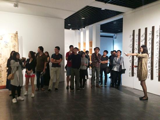 策展人艺婷(右一)在展览现场导览