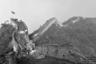 箭扣长城鹰飞倒仰段,满山红叶和工地上飘扬的国旗交相辉映。京华时报记者王海欣摄