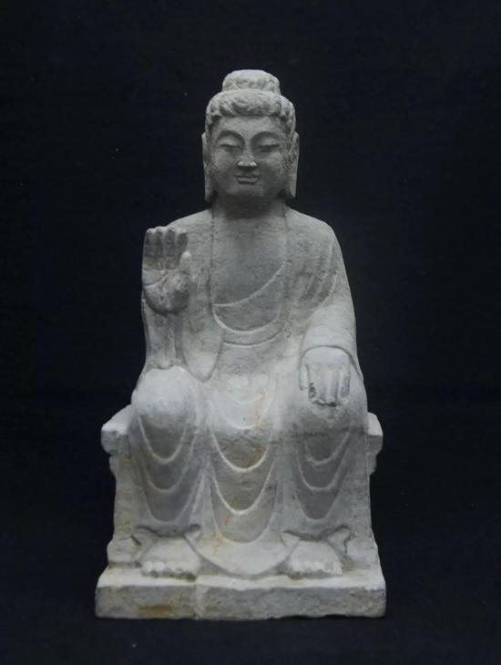 (宗教文化艺术展品赏析/石佛像) 右手上举至胸前,掌心向外,五指自然伸展。
