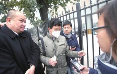 李某的父亲(戴口罩者)来到市三中院旁听审理。