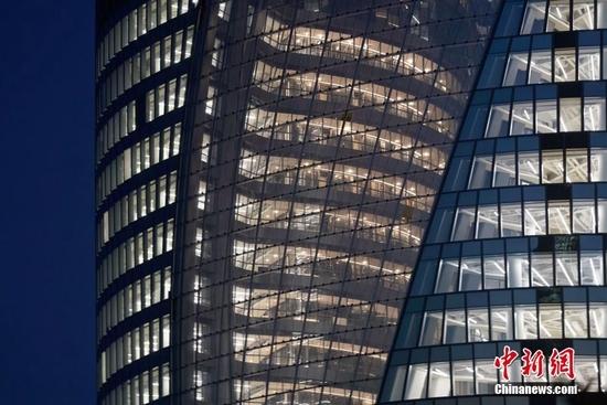 资料图:北京一双螺旋造型写字楼亮灯调试。中新社记者 苏丹 摄
