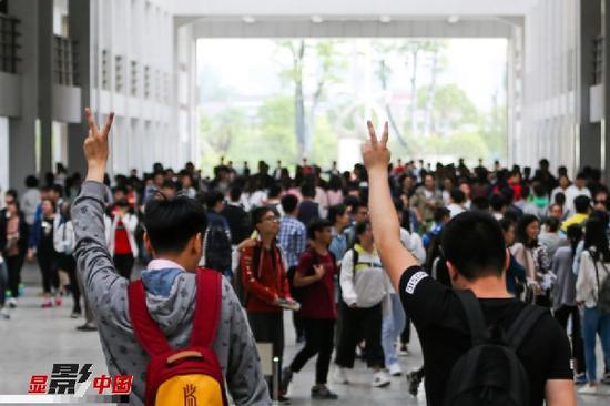 6月7日,在江苏省扬州市仙城中学高考考点,两名考生摆出胜利手势进入考场。当日,2017年高考拉开帷幕,全国高考报名考生共940万人。新华社发(郁兴摄)