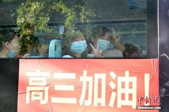 资料图:2020年7月,广西南宁沛鸿民族中学内,高三学生乘坐高考专车前往考点。 中新社记者 俞靖 摄