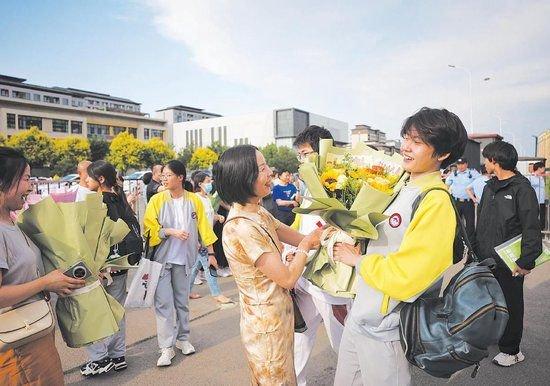 6月9日,人大附中通州校区考点,家长给考完的孩子送上鲜花。新京报记者 薛珺 摄