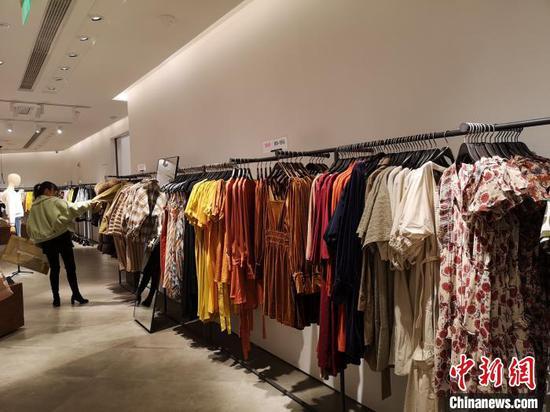 一位女性正在挑选衣服。 唐小晴 摄
