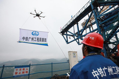 Workers prepare for linking pilot cable of highway bridge under construction in Guizhou