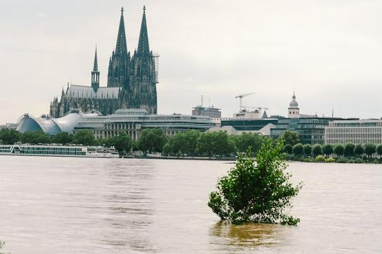 The bank of the river Rhine is seen flooded in Cologne, western Germany, July 15, 2021. (Photo by Tang Ying/Xinhua)