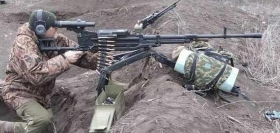 图为使用Kord-12.7重机枪射击的步兵,其三脚架前安置了重物,用于压住枪架防止上抬。