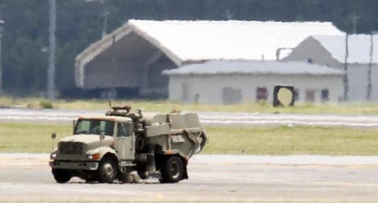 正当F-35“跪着”时,一辆垃圾清扫车慢慢悠悠地驶过跑道