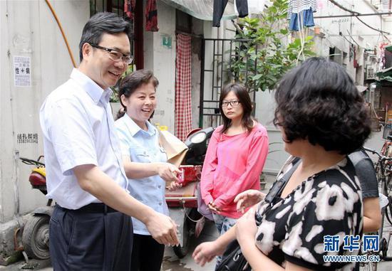 邹碧华(左一)在社区走访时与群众交流(2013年9月29日摄)。 新华社发