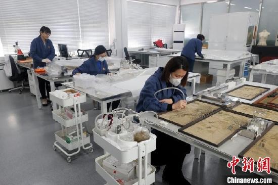 故宫博物院文保科技部织绣组的姑娘们正在修复文物 杜洋 摄