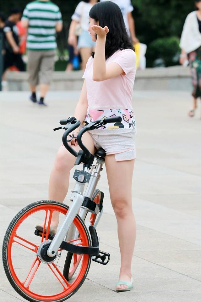 街拍: 白色纯棉热裤+粉红短袖t恤的美女骑单车