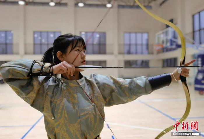 图为女生射箭。