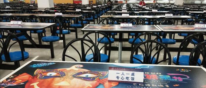 北京科技大学学生专用食堂,餐桌上放了“一人一桌”的标志牌。受访者供图