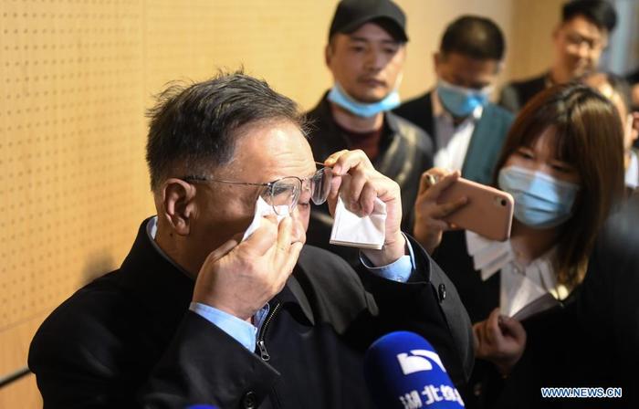 Zhang Boli (1st L), an academician of the Chinese Academy of Engineering and head of Tianjin University of Traditional Chinese Medicine, wipes tears during his visit at the makeshift hospital in Jiangxia District in Wuhan, central China's Hubei Province, April 9, 2021. Featuring traditional Chinese medicine treatment, the makeshift hospital in Wuhan's Jiangxia District was transformed from a sports center. It received a total of 564 patients till its closure on March 10, 2020. None of them saw their health condition deteriorate. (Xinhua/Cheng Min)