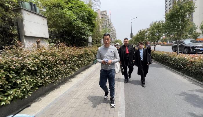 庭审结束后陈先生和律师一起走出法院。新京报记者 俞金旻 摄