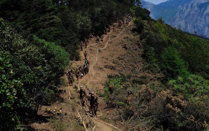 直击木里山火：村民连夜送水至火场，消防员扑灭百年大树火点