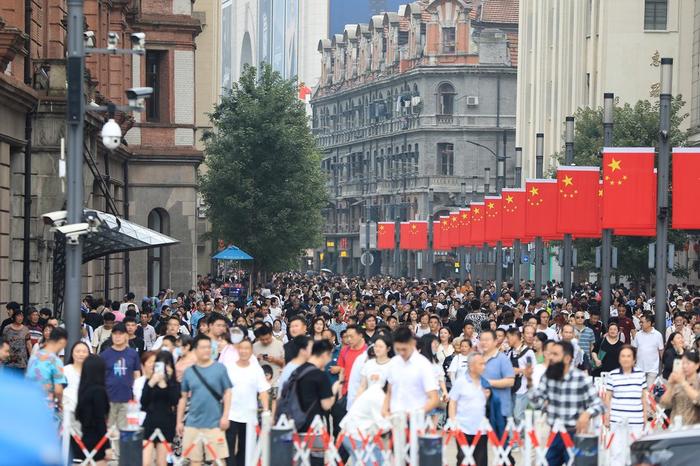 9月29日,上海南京东路步行街国旗飘扬,游客欢度佳节,热情高涨 图片来源:东方IC