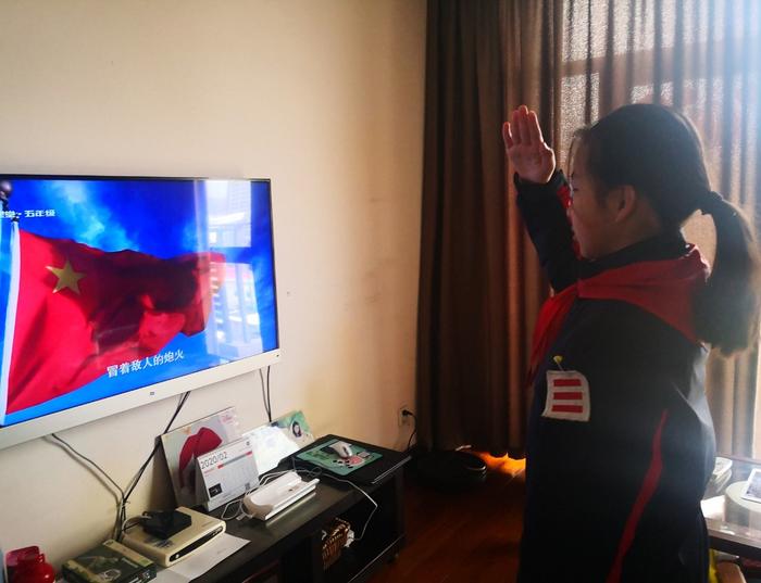 图片说明:正在参加升旗仪式的小杰
