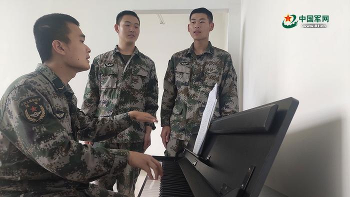 会弹钢琴的郑裕泰(左一),与战友一起弹唱《我把太阳迎进祖国》。迟 博摄
