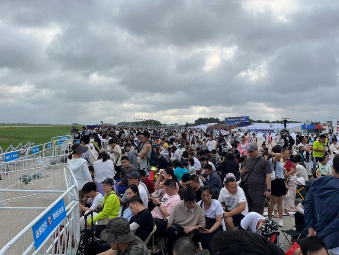 距离开场还有3小时,双层栅栏后已经坐了十几排人