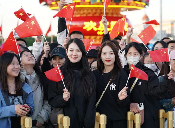 10月1日,在观看升旗仪式后,人们在北京天安门广场留影。新华社记者 张晨霖 摄