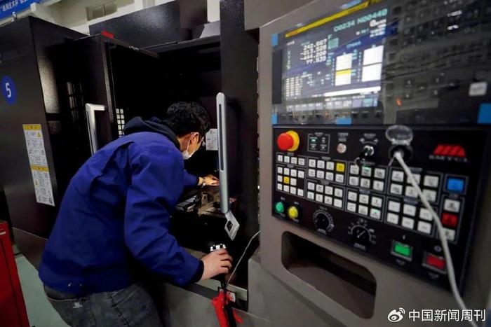 参赛选手在数控多轴加工比赛中比拼。图/新华