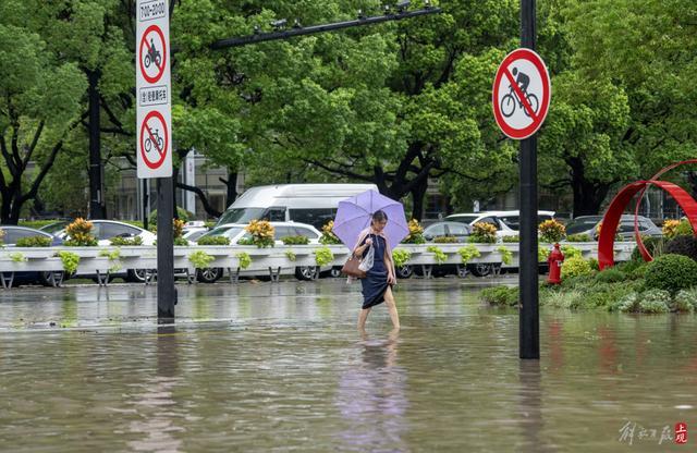 浦东遭遇暴雨，市政工人全力排水，外卖小哥“摆渡”市民过街