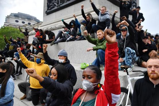 People take a knee and gesture in Trafalgar Square during a “Black Lives Matter” protest in London, Britain, June 3, 2020。 REUTERS/Dylan Martinez