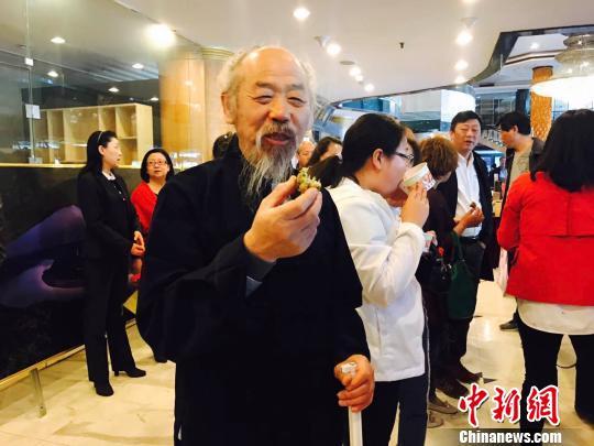 永和槐花扶贫活动现场人们品尝槐花团子赞不绝口。 任丽娜 摄