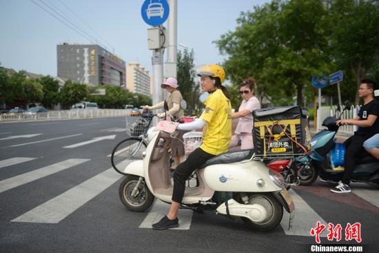 资料图:外卖骑手正在送餐。中新网记者 富宇 摄