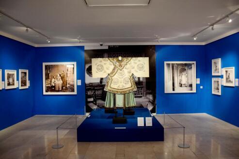 展厅里展出的服饰和照片。(图片来源:英国《英中时报》)