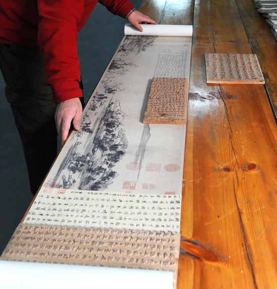 魏立中正在查看木刻水印的富春山居图。