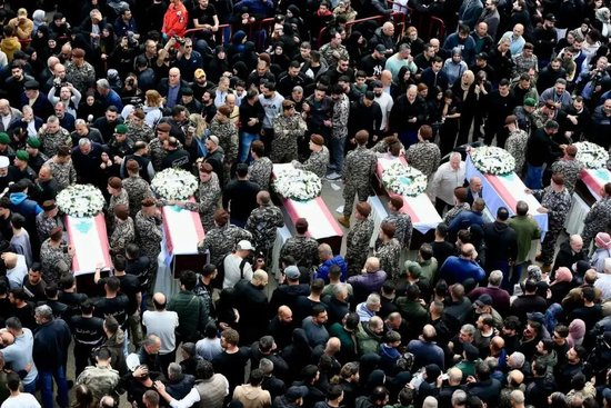 当地时间2026年4月11日，在黎巴嫩西顿市，人们参加遭以军空袭丧生的13名安全人员的葬礼/新华社发（阿里·哈希绍 摄）