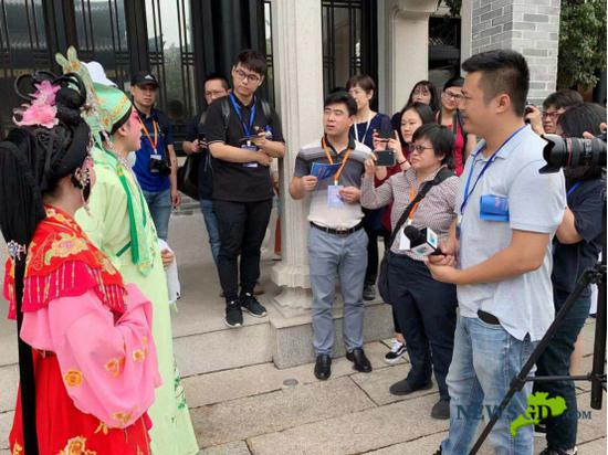 两名粤剧演员表演完毕被记者们团团围住。