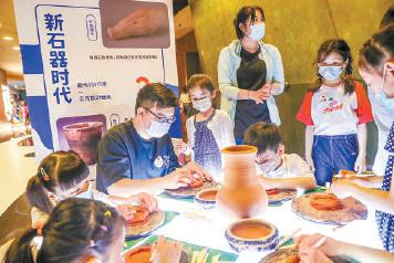  昨晚，在首都博物馆悦空间，小朋友们体验陶艺制作，了解文物知识。本报记者 武亦彬摄