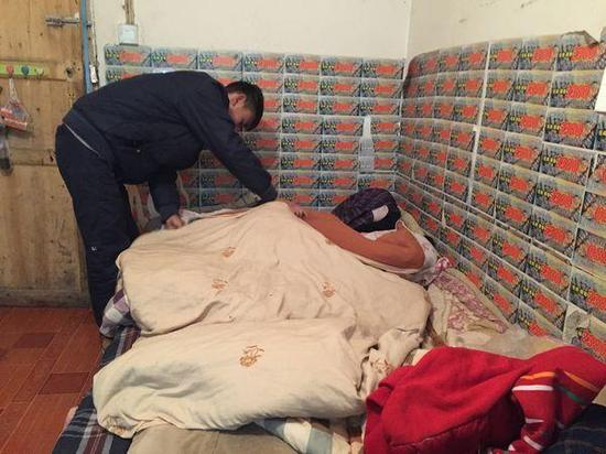 在熊先生提供的小屋里，王亮正在为妹妹盖被子。上游新闻记者 张曼双 摄