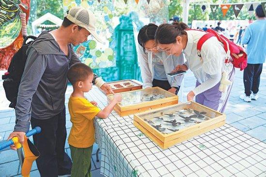 7月20日，玉渊潭公园，孩子们在趣味科普体验活动中熟悉园林生态。本报记者 刘平摄