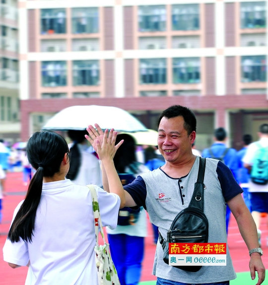 　　昨日高考第一天，东莞中学考点，一位等在考场外的家长看到考试顺利结束的考生，开心地与她击掌庆祝。南都记者 刘媚 摄