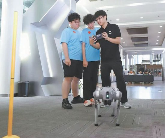 工程师正在指导学生上手操作机器狗。