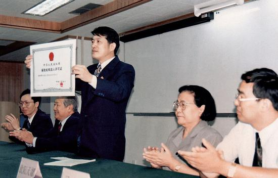 1996年，陈东升展示新拿到的保险机构法人许可证。来源：被访者供图
