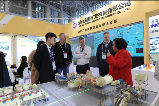 ▲2024中国国际矿业大会上，金鹏矿机董事长于建环（右一）与国内外客户进行交流