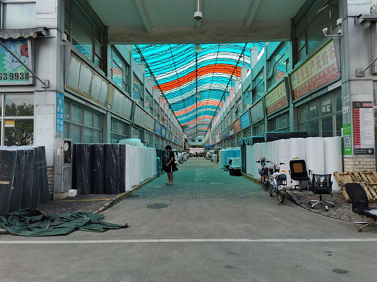 （纺织服装交易市场中，几乎难觅顾客身影）