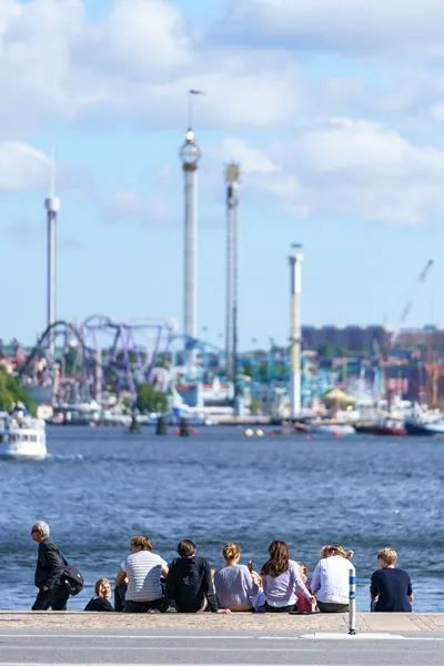 ▲人们在瑞典斯德哥尔摩的海边休闲。新华社资料