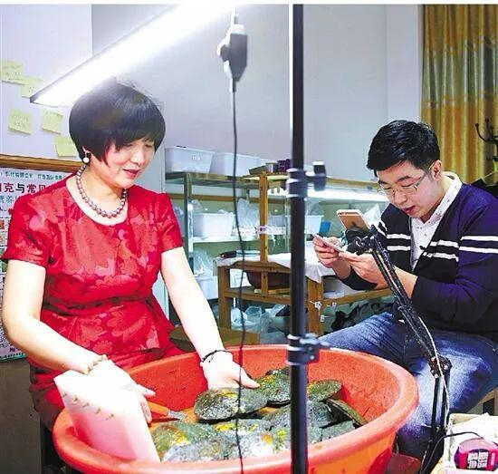 当年在淘宝直播走红的珍珠哥，在简陋的店铺里和母亲一起直播。