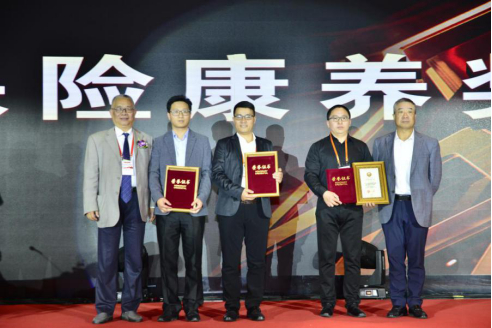 论坛终身名誉主席罗忠敏，中国保险康养产业联盟轮值会长何志光为获奖单位代表颁奖